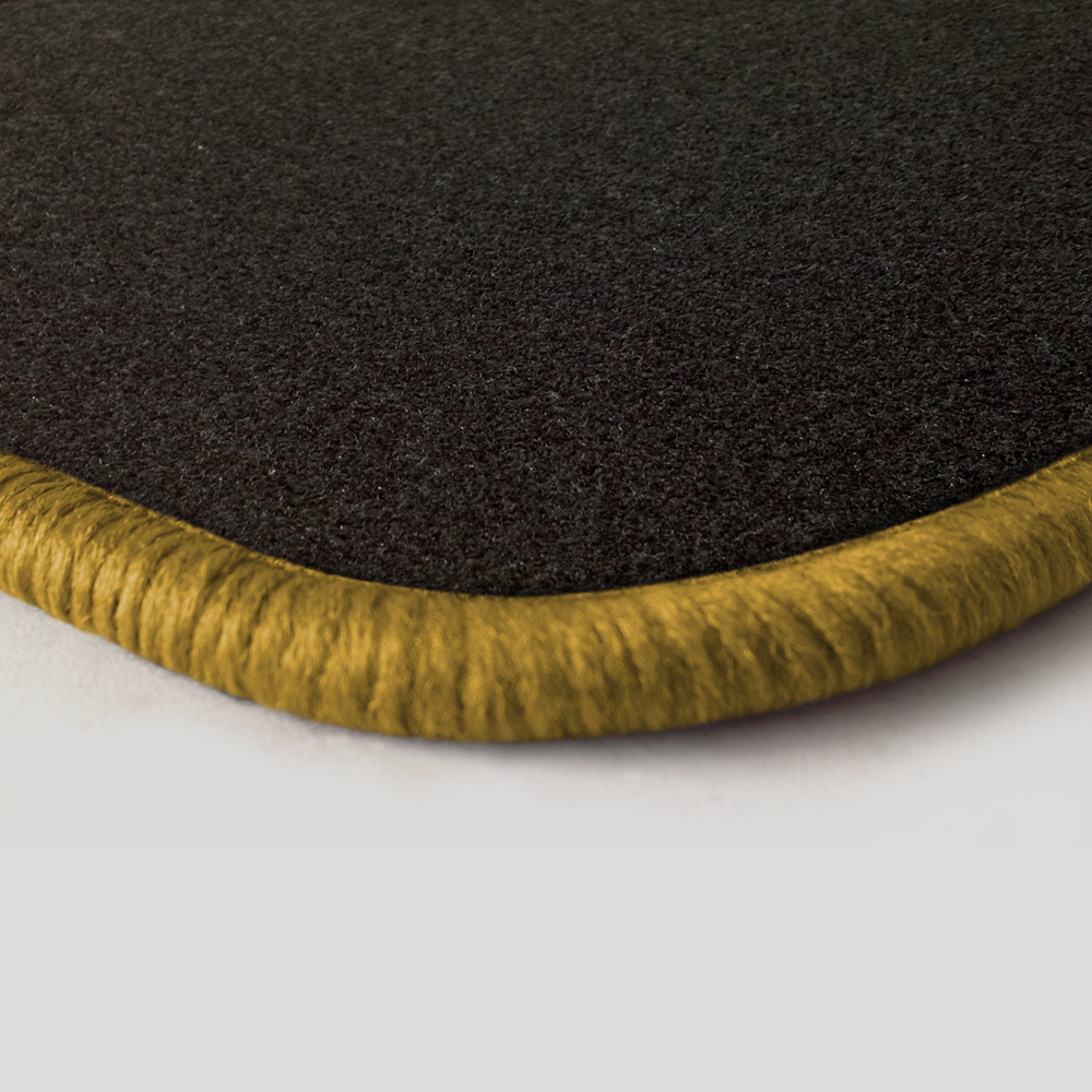 Eine Ecke als Beispiel einer Fussmatte Nadelfilz schwarz mit Rand in gold.